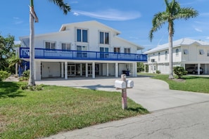 Both sides of this beach duplex, on a quiet, residential street and canal are available to rent; this listing is for the unit on the right.