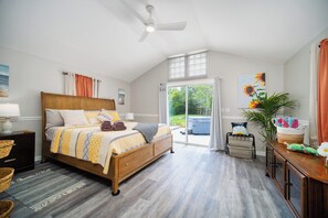 Bright master bedroom with king bed, vaulted ceilings, and direct access to the patio hot tub.