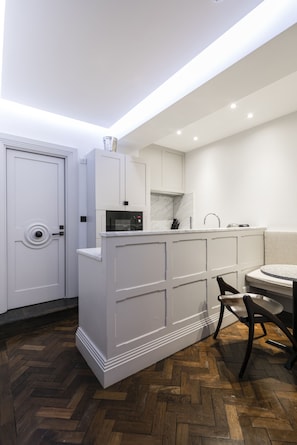 The kitchen includes all the modern appliances you would expect, fridge, freezer, oven, microwave, kettle, coffee maker. The dining area can seat up to 4 people. The kitchen leads on to a guest toilet with washing machine and dryer area, 