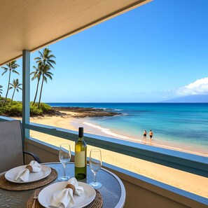 Enjoy wine and ocean breezes from your lanai, perched above a secluded beach with views of Molokai in the distance NAB-107