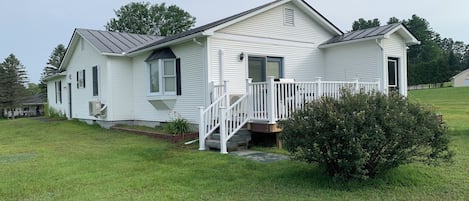 Back of house showing deck and yard.