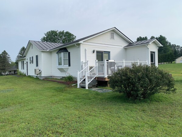 Back of house showing deck and yard.