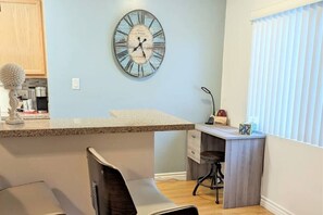 Bar countertop off the kitchen, with a desk to work at as well.