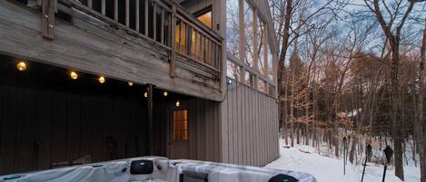 Jacuzzi and back exterior of the house in the wintertime. 