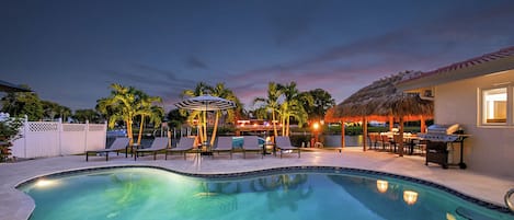 Escape to a private Delray Beach paradise: Featuring an amazing  pool, cozy loungers, a sun shelf, and surrounded by palm trees, our secluded retreat is your ideal vacation haven.