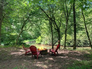 Fire pit next to river steps away from the front door! The most unique aspect! 