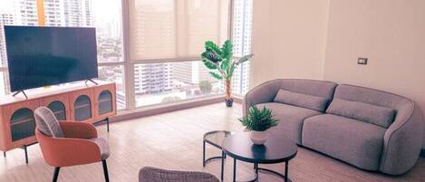 BRIGHT LIVING ROOM WITH FLOOR TO CEILING WINDO