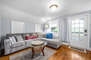 Living Room w/ Full-sized Sleeper Sectional and Smart TV