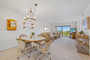 Open dining area with a stylish table set, perfect for shared meals and ocean views.