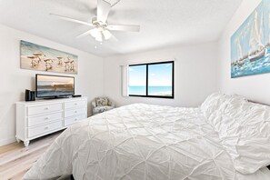 Serene bedroom retreat with soft, airy tones, cozy bedding, and a view that invites relaxation.