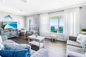 Nothing beats lounging on the couch and watching TV in the living room, plus a view of the ocean.