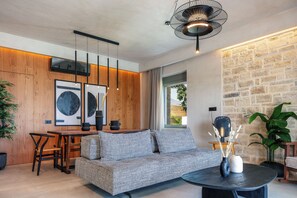 Living room area with a 50’’ smart TV, board games and a Bluetooth speaker