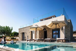 The pool area is accompanied by 4 sun beds, a double day bed, side tables, a poolside shower, and 2 umbrellas for a truly comfortable poolside experience