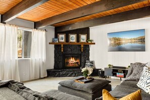 Enjoy the 65 inch smart TV, comfortable sectional couch, board games available, wood burning fireplace and soundbar/subwoofer in the living room space.