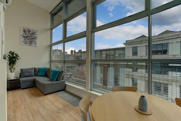 Bright & spacious living area with floor to ceiling windows