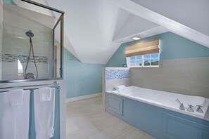 The attached bathroom has both a shower and bath tub.