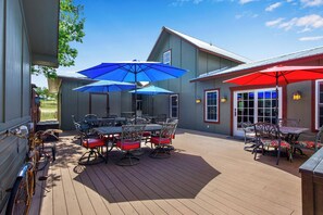 Large communal deck with lots of dining/seating for guests.