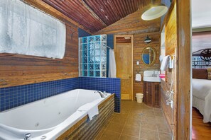 Attached bathrooom with both shower and bath tub.