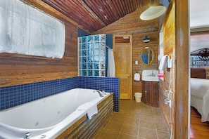 Attached bathrooom with both shower and bath tub.