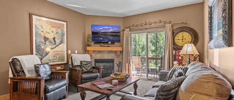 Bear Hollow Lodges 1304:  The living room has cozy seating, a warm gas fireplace and even room and amenities to accommodate your four-legged family members.