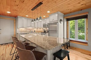 Contemporary dining ambiance with a cozy window alcove offering a glimpse of the outdoors
