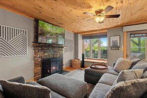Living room escape: Where nature peeks in through sleek glass panels, inviting the outdoors while a subtle hint of wildlife whispers its story.