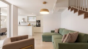 A spacious living room with a comfortable sofa bed for two additional people inside a private luxury villa