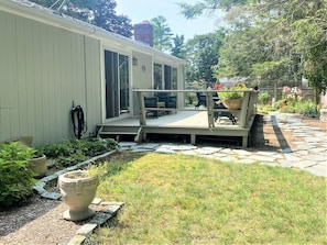 Back deck with outdoor seating and gas grill.