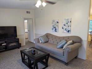 Comfy living space with footstools under coffee table.