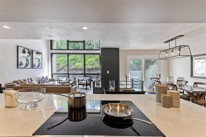 Kitchen overlooking main living room & dining space; outdoor deck off living roo