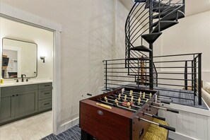 Rec Room with Foosball table, second living room, spiral staircase 