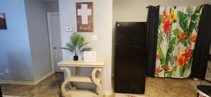 Laundry closet with washer and dryer behind the tropical curtains 