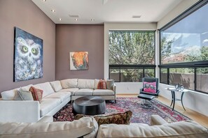 Living room with large sectional and sleeper sofa.