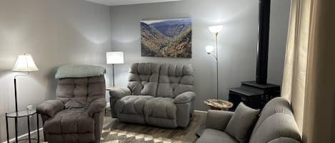 Our cozy living room has a recliner, a reclining loveseat, fold out queen sofa.