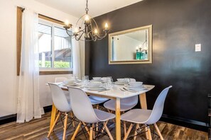 Indoor dining table space directly beside the kitchen and living room.