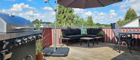 Enjoy wonderful sunsets and a view on the rooftop terrace with big gas grill