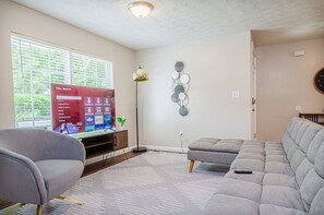 Enjoy your favorite shows or movies on the big screen in this inviting living room. The comfortable seating and stylish decor make it the perfect place to relax after a long day.