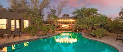 Beneath the star-studded sky, our yard transforms into an ethereal sanctuary - the pool's gentle ripples mirroring constellations while the gazebo offers a cozy retreat for nighttime reverie