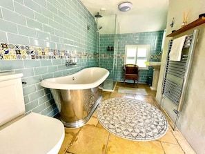 Bathroom with roll-top bath and separate shower.