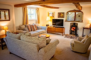 Cosy living room with log burner.