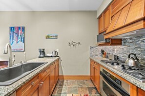 Full kitchen with stainless steel appliances and granite countertops