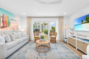 This designer living room is an open space for family and friends to share conversation, play "Florida-poly" or the Gray Malin Backgammon board, read an array of coastal and tropical books, or enjoy your favorite shows on the large 65" TV.