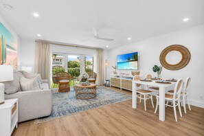 This designer living room is an open space for family and friends to share conversation, play "Florida-poly" or the Gray Malin Backgammon board, read an array of coastal and tropical books, or enjoy your favorite shows on the large 65" TV.