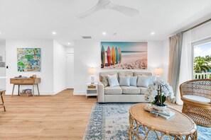 This designer living room is an open space for family and friends to share conversation, play "Florida-poly" or the Gray Malin Backgammon board, read an array of coastal and tropical books, or enjoy your favorite shows on the large 65" TV.