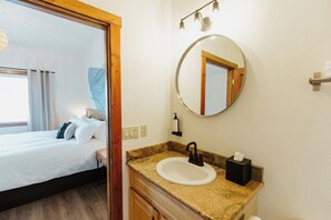 [Bathroom] A private bathroom with a tub is accessed through the bedroom. 