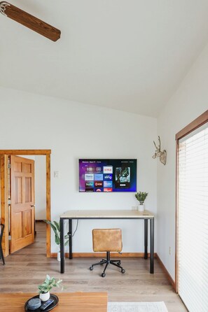 [Office area] Our suite features a large electric standing desk so you can work remotely.