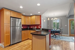 combination kitchen, dining room opens to screen porch