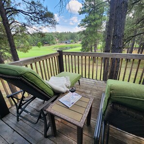 Chaise lounges w/ golf course & forest views.