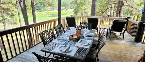 Covered outdoor dining w golf course views.