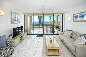 Spacious lounge with the balcony & ocean beyond